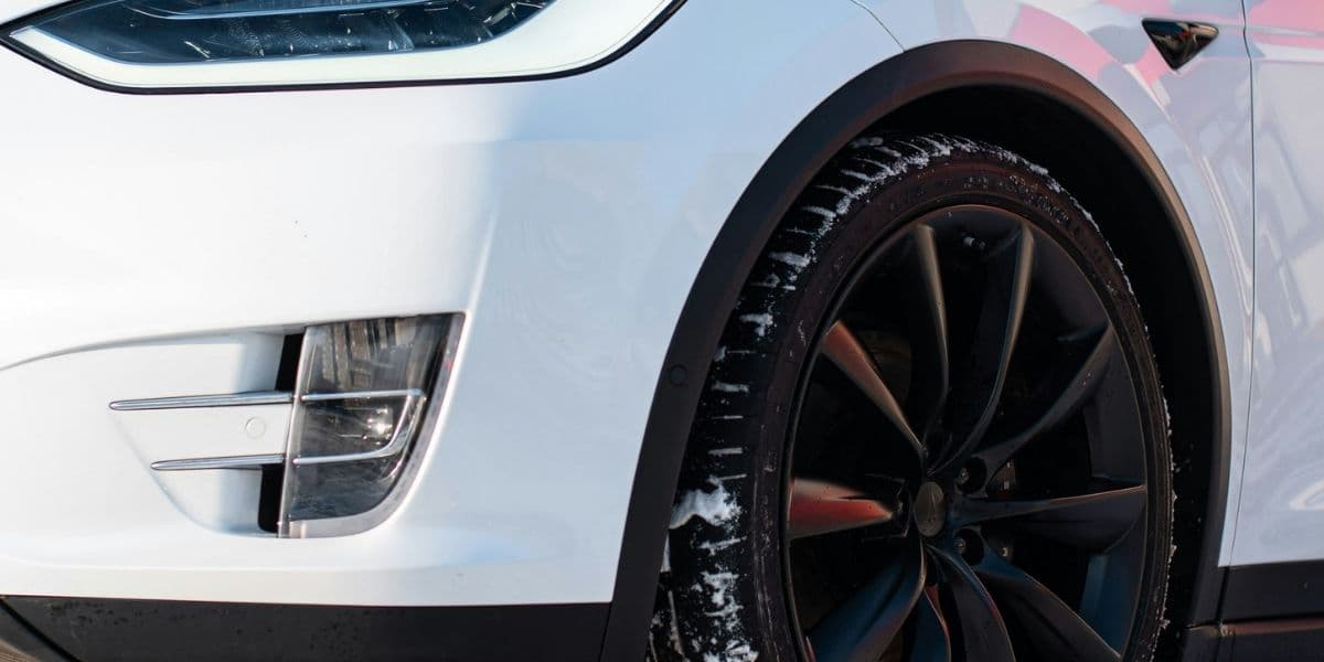 Tesla winter tire and wheel in deep snow