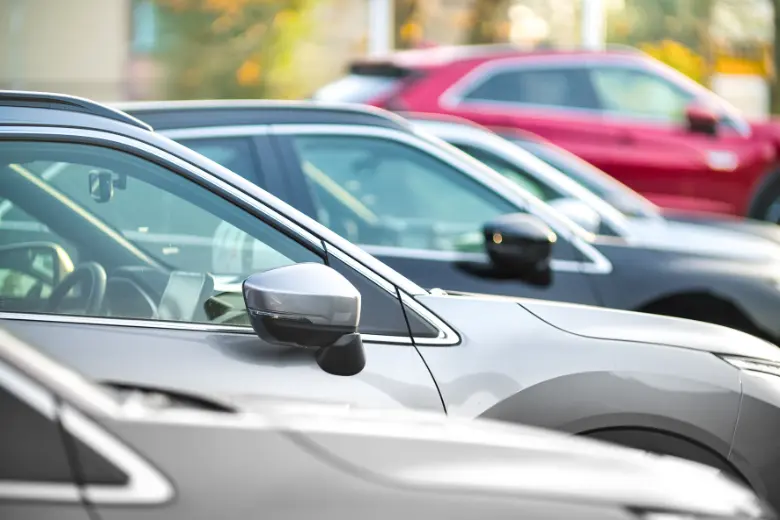Row of late-model used cars for sale at a dealership