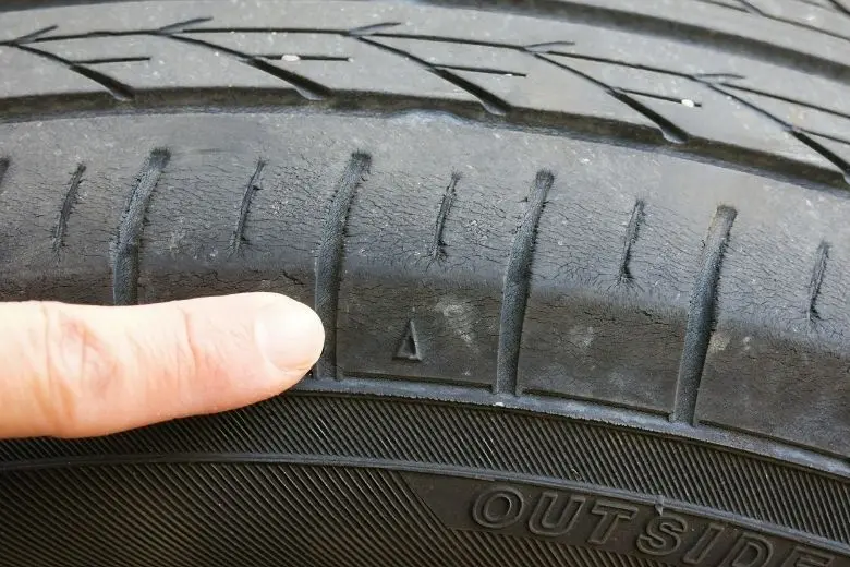 Dry rot cracks on a used car tire sidewall